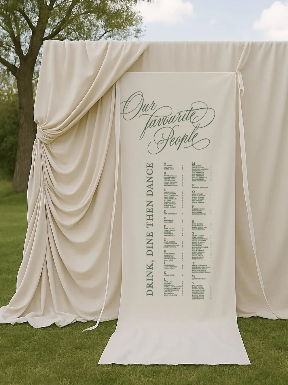 A draped linen seating chart standing on a lawn